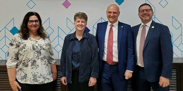 Members of the Purdue Applied Research Institute’s Global Development and Innovation (GDI) division at the debut of the Jordan Cyber Academy in Amman. From left: Margaret McDonough, GDI’s director of practice; Ginger Bolen, GDI’s associate director for the project management unit; John Glover, GDI executive director; and Joel Rasmus, CERIAS managing director. (Purdue University photo)